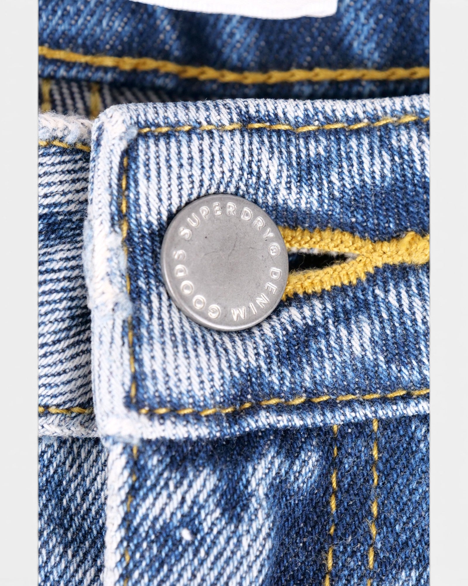 Shorts Superdry Bermuda Boy Short in denim mid indigo authentic with yellow mustard contrast stitching and raw frayed hem.