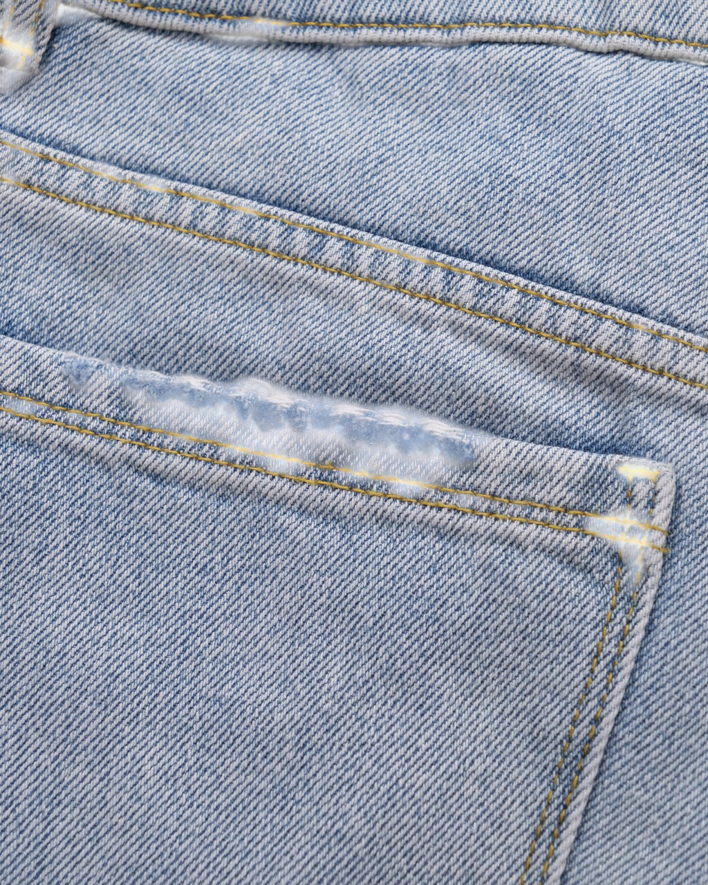 ULTIMATAGLIA.COM light blue denim Bermuda boy shorts with stone-wash, hand-frayed hem and distressed front detail.