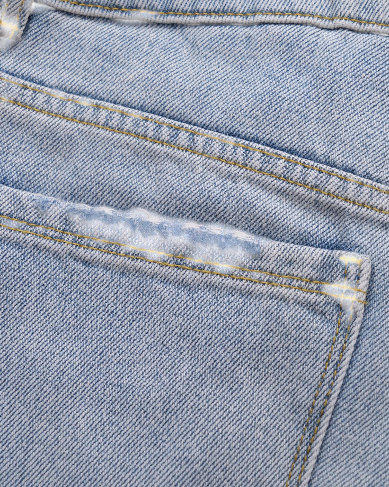 ULTIMATAGLIA.COM light blue denim Bermuda boy shorts with stone-wash, hand-frayed hem and distressed front detail.