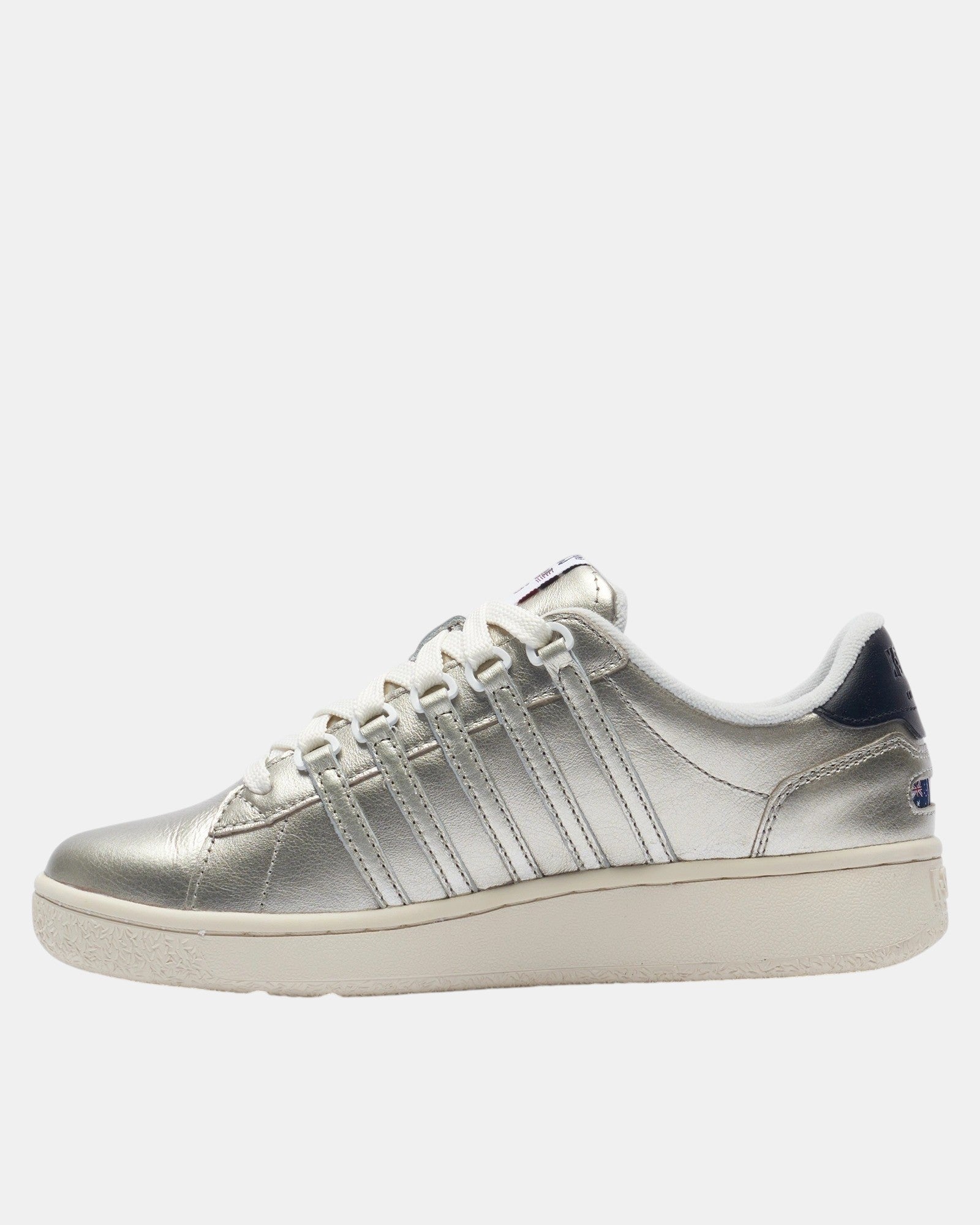 ULTIMATAGLIA.COM K-SWISS Slammclassic CC women's champagne leather sneakers with white laces and navy heel detail.