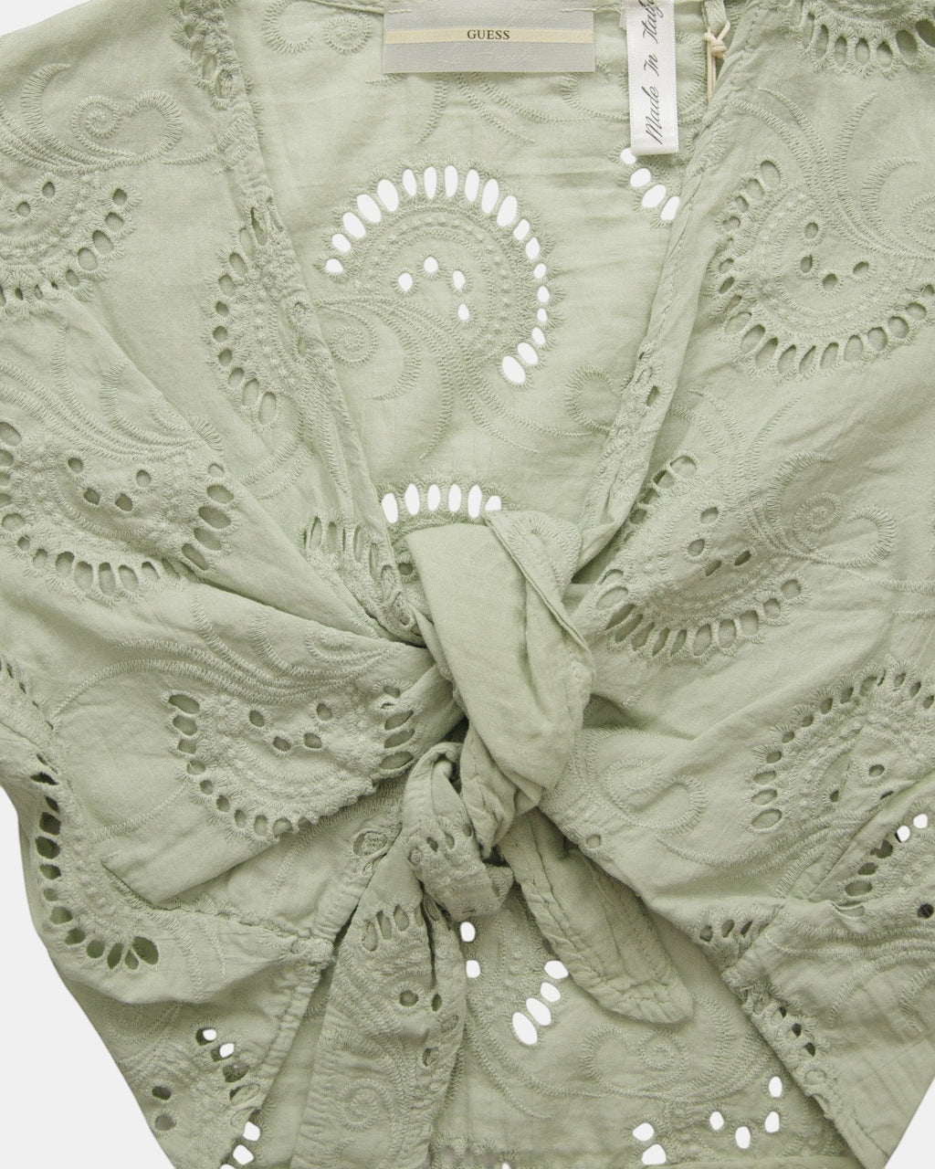 ULTIMATAGLIA.COM Guess green cotton blend short top with floral embroidery, V-neck, and tie front.