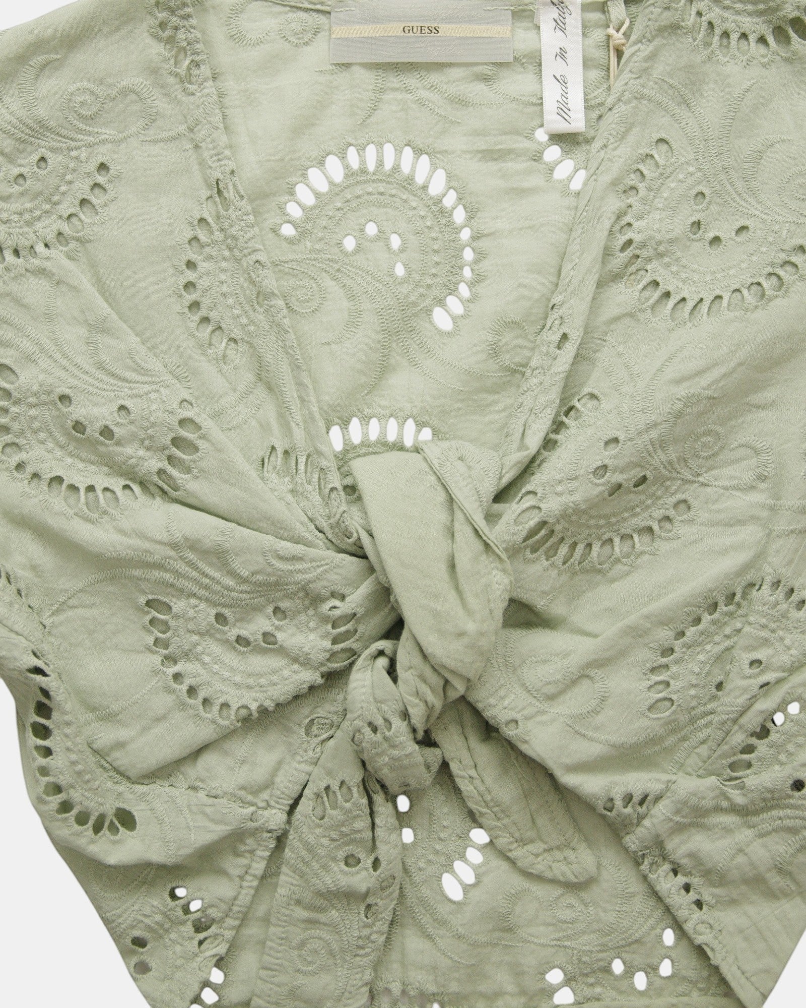 ULTIMATAGLIA.COM Guess green cotton blend short top with floral embroidery, V-neck, and tie front.