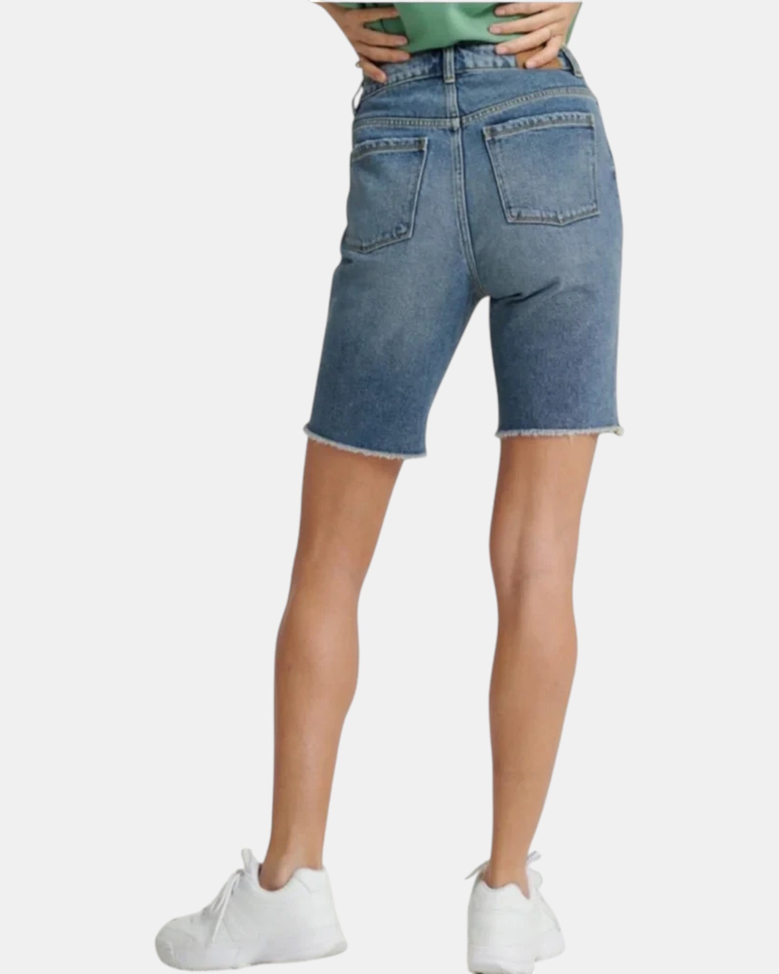 ULTIMATAGLIA.COM Bermuda Boy Short in mid indigo denim with frayed hem and five pockets.