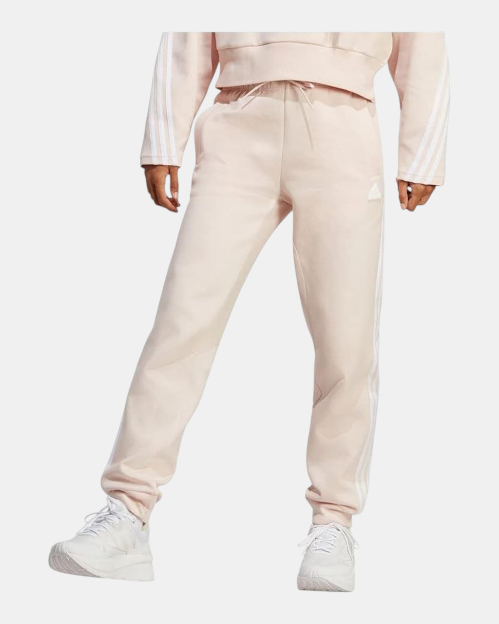 ULTIMATAGLIA.COM Pantaloni Adidas beige in fleece con tre strisce laterali e cordoncino in vita. Taglio dritto.