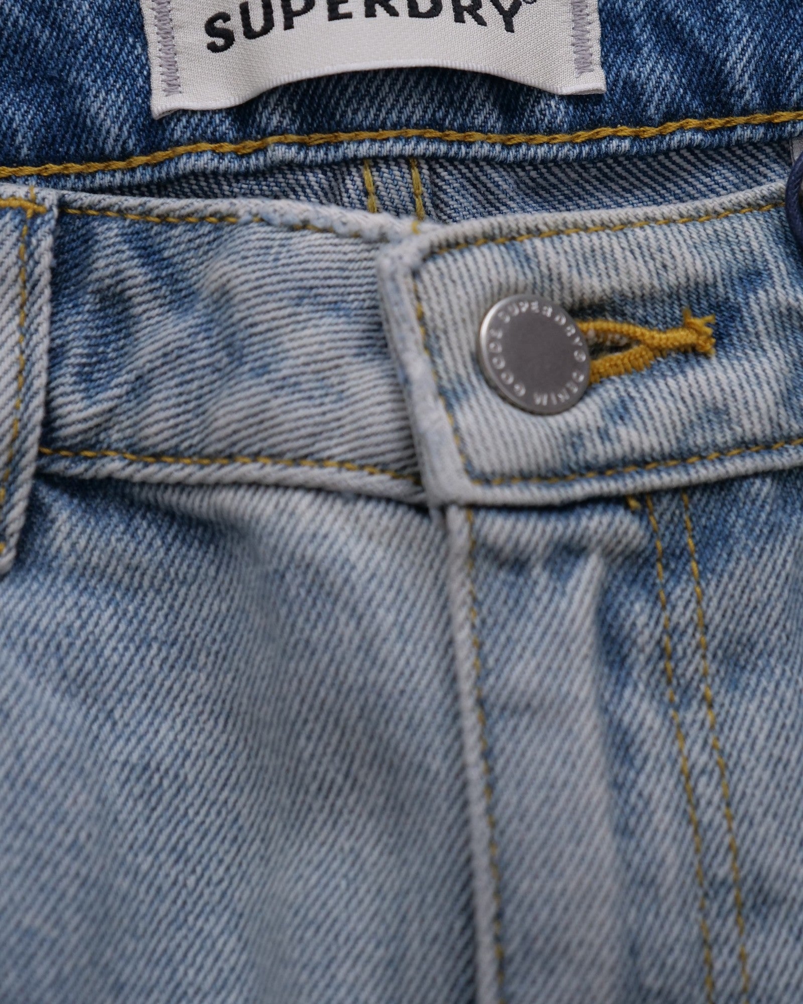 Shorts Superdry Bermuda Boy Shorts in light blue denim with stone-wash, frayed hem, and distressed front detail.